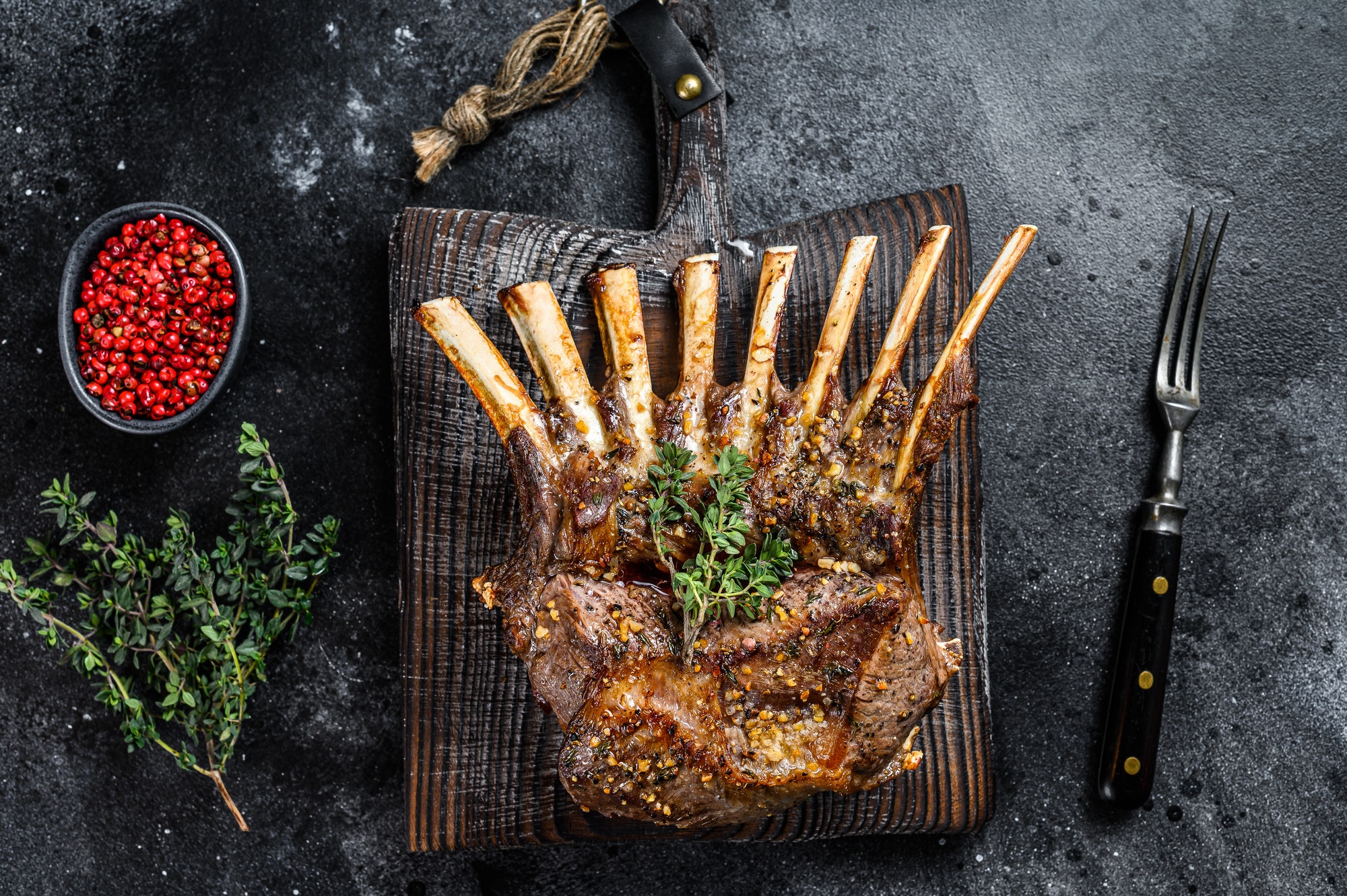 Barbecue rack of lamb meat chops. Black background. Top view