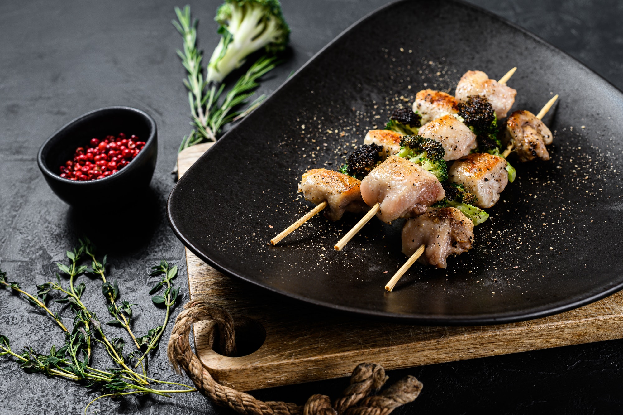 Barbecued Turkey breast skewers. Shish kebab. Black background. Top view