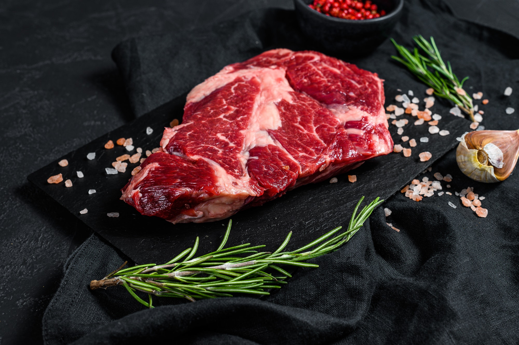 Raw black Angus steak. Organic farm beef black Angus. Black background